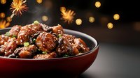 Glazed chicken pieces with sesame seeds in brown ceramic bowl against dark background with festive bokeh lights, garnished with green onions and spices.