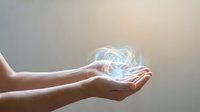 Hands holding glowing energy orb with light trails. Concept for healing, spirituality, magic, power, technology, innovation and mystical energy visualization.