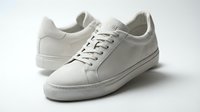 Minimalist white suede sneakers on a light background, showcasing clean design and casual style for fashion, footwear, and lifestyle concepts.