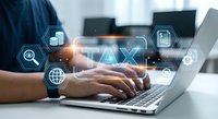 Professional accountant working on laptop with digital tax interface and financial icons overlay for business taxation services.
