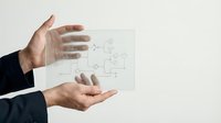 Businessman hands protecting transparent glass with network connectivity icons representing digital security and data protection in modern workplace.