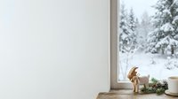 Cute dog sitting on windowsill looking outside at snowy winter landscape with evergreen trees, cozy home interior scene for seasonal and pet-related projects.