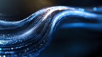 Glowing blue wave of light particles flowing in dark space creates dynamic motion effect with sparkles and bokeh elements for technology backgrounds.