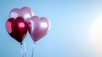Romantic heart-shaped balloons in pink and burgundy colors floating against soft blue background, creating dreamy atmosphere for Valentine's day celebrations and love themes.