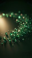 Emerald glitter and bokeh lights cascade across dark surface, creating luxurious festive atmosphere. Ideal for holiday, celebration, and premium design projects.