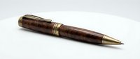 Luxury ballpoint pen with dark wood barrel and brass accents, isolated on white background, suitable for business stationery design and corporate branding projects.