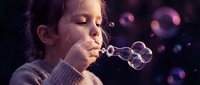 Young girl blowing soap bubbles with colorful bokeh lights in background. Child enjoying playful moment creating floating spheres in magical atmosphere.