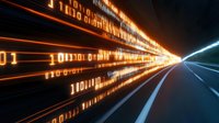 Glowing binary code streams along futuristic highway with orange and blue light trails creating dynamic perspective effect against dark background. Digital data flow concept.