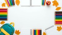 Colorful school supplies frame with pencils, notebooks and autumn leaves on white background for back to school creative projects and educational designs.
