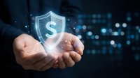 Businessman hands holding glowing dollar shield icon representing financial protection, investment security and money safety in digital technology background.