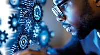 Young African American male professional in glasses analyzing digital gear interface visualization with blue technological background for business analytics.
