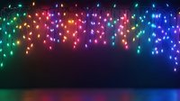 Colorful glowing Christmas lights hanging against dark background with reflection on glossy surface, creating festive holiday atmosphere.
