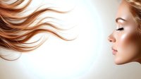 Side profile of young woman with flowing ginger hair against white background, showcasing natural makeup and closed eyes in serene expression. For beauty and hair care advertising.