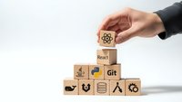 Hand placing wooden cube with atom symbol completing pyramid of programming technology blocks including React and Git on white background.