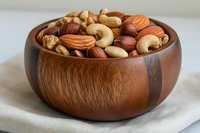 Mixed nuts in wooden bowl on linen cloth featuring almonds cashews walnuts hazelnuts for healthy snacking and cooking ingredients.