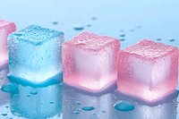 Glowing pink and blue ice cubes with water drops on reflective surface create magical mood lighting effect, suitable for party decoration and beverage photography.