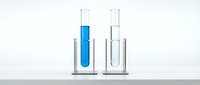 Laboratory test tubes with blue liquid and clear liquid in glass beakers on white background for scientific research and chemical analysis.