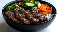 Korean BBQ beef bulgogi bowl with glazed meat, fresh vegetables, pickled carrots and steamed rice in black ceramic bowl for Asian cuisine restaurant menu.