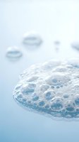 Clear water bubbles floating on calm blue surface creating peaceful spa and wellness atmosphere for relaxation and skincare concepts.