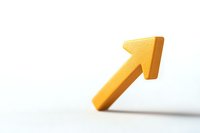 Yellow diagonal arrow pointing upward on white background, symbolizing growth, success, and positive direction in business and financial concepts.
