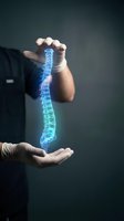 Doctor hands protecting glowing blue spine hologram for medical healthcare and orthopedic treatment concepts in modern clinical environment.