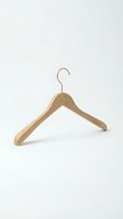 Wooden clothes hanger with a gold metal hook isolated on a white background, for fashion, retail, wardrobe organization, and clothing store concepts.