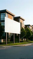 Modern residential development with contemporary townhouses featuring wood siding, large windows and landscaped yards in suburban neighborhood setting.