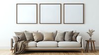 Modern living room interior with beige sofa, decorative pillows, and three empty square frames on white wall. Minimalist contemporary home decor setup with side table and dried flowers.