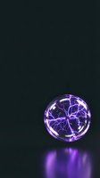Glowing plasma ball with purple electric arcs and lightning bolts inside glass sphere on dark background, suitable for sci-fi, technology, and energy concepts.