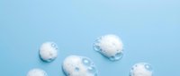 Fluffy white clouds floating on soft blue background, isolated design elements for web, print, and creative projects.