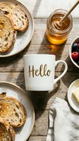 Cozy morning breakfast flatlay with white ceramic mug, toasted bread, honey jar, fresh berries, and butter on rustic wooden table.