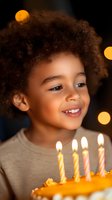 Happy mixed-race child celebrating birthday with cake and candles in warm bokeh lighting for party celebrations and childhood milestone moments.