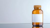 Amber glass medicine bottle with blank white label on reflective surface against light gray background, pharmaceutical packaging mockup for medical products.