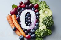 Fresh fruits and vegetables arranged in number zero shape with blueberries, grapes, carrots, kiwi and broccoli on light background, healthy eating concept.