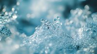 Macro shot of crystalline ice formations with sparkling frozen water droplets and bokeh background, suitable for winter themes and nature backgrounds.