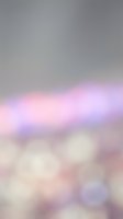 Soft blurred gradient background with pink, purple, and blue bokeh lights transitioning to neutral gray tones, suitable for overlays and design backdrops.