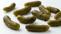 Pickled gherkins and dill cucumbers isolated on white background, ready for food packaging, recipe blogs, grocery store marketing, restaurant menus and culinary design projects.