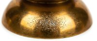 Golden brass singing bowl with intricate mandala patterns engraved on surface for meditation, sound therapy, healing practices and spiritual wellness rituals.