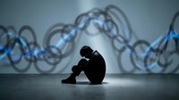 Silhouetted male figure sitting in dejected pose against industrial chain link backdrop, conveying depression, stress, and emotional struggle in modern environment.