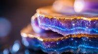 Stacked translucent resin layers with golden and blue iridescent effects, isolated on dark background. Suitable for abstract design, backgrounds, and creative projects.