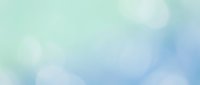Soft pastel blue and green watercolor background with gentle cloud-like textures for creative projects and design applications.