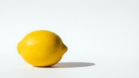 Fresh yellow lemon fruit isolated on white background with shadow. Natural citrus ingredient for cooking, beverages and healthy nutrition concepts.