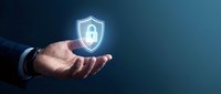Businessman hand holding glowing padlock shield icon representing cybersecurity, data protection, and digital safety solutions for business and technology concepts.