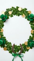 Flat lay frame made with green four-leaf clovers, gold coins, leprechaun hats, horseshoe and ribbon on white background for St. Patrick's Day celebrations and festive designs.