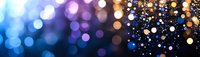 Magical bokeh lights creating dreamy atmosphere with blue and gold glowing circles on dark background, abstract defocused panoramic view for festive design.