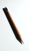 Single wooden brush with black bristles and natural wood handle isolated on white background, ready for design and art projects.