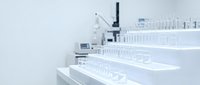 Modern laboratory interior with rows of test tubes and scientific equipment for medical research and pharmaceutical development.