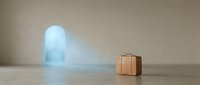Vintage brown leather suitcase on wooden floor with glowing blue neon arch doorway in background, travel and adventure concept for design projects.