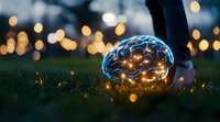 Glowing neon brain on grass with magical bokeh lights at dusk creates surreal atmosphere. Concept of mind, intelligence and creative thinking in nature setting.
