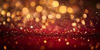 Red and gold glowing bokeh lights on dark background with sparkle effect, creating magical festive atmosphere for holiday designs and celebrations.